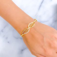 This exquisite 18k gold bangle, weighing 17.2 grams, features a unique striped wavy design adorned with dazzling diamonds. The yellow gold finish enhances its luxurious appeal, making it perfect for any occasion. The bangle is set with 0.62 carats of F-G color, VS quality diamonds in round brilliant cut shapes. With an oval opening of 2.3 inches, this piece offers both elegance and comfort. The bangle is openable, designed with a hinge and a clasp with a lock for added convenience. Ideal for tho Modern Cubic Zirconia Gold Bangle Bracelet, Elegant Yellow Gold Bangle With Diamond Accents, Adjustable Yellow Gold Elegant Bangle, Gold Plated Jubilee Diamond Bangle Bracelet, Flexible Gold Diamond Bangle, Yellow Gold Diamond-cut Bangle Bracelet, Yellow Gold Diamond-accented Cuff Bangle, 18k Gold Bangle, Quality Diamonds