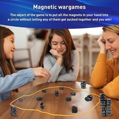 two girls and one girl are playing a game with magnetic dices on the table