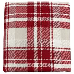 a red and white plaid pillow on a white background