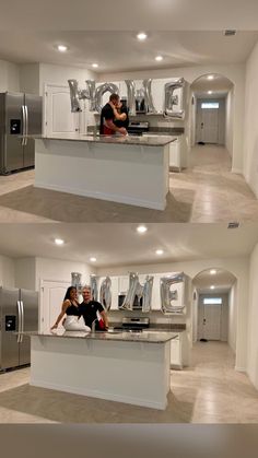 two people are sitting at the kitchen counter in front of an oven and refrigerator with letters on it