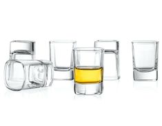 several shot glasses are lined up next to each other, with one empty glass in the middle