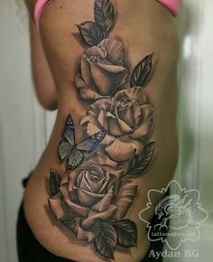 a woman's stomach with roses and a butterfly on it