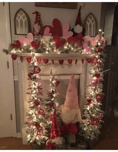 a fireplace decorated for christmas with lights and decorations on the mantel, including a gnome's hat