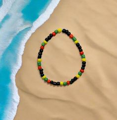 Represent your Island in style with our Grenada Beaded Bracelet More Islands available at Tasteofjamaicauk.com Available in 6 sizes Tiny 5 - 5.5 inches  XS 6 - 6.5 inches  S 6.5 - 7 inches  M 7 - 7.5 inches  L 7.5 - 8 inches  XL 8 - 8.5 inches Materials: Glass seed beads (4mm) Includes a free jewellery bag to keep your bracelet safe. Black Beaded Bracelets With Large Beads For Beach, Black Beaded Bracelets For The Beach, Beach Friendship Bracelets With Round Wooden Beads, Beach Wooden Beads Friendship Bracelets, Multicolor Beaded Bracelets With Black Beads For Beach, Casual Beach Stretch Bracelet With Wooden Beads, Casual Wooden Beads Stretch Bracelet For Beach, Black Beaded Bracelets For Vacation, Multicolor Casual Bracelet With Black Beads