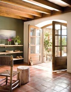 a living room filled with lots of furniture and decor on top of brick flooring