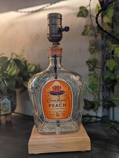 an old fashioned liquor bottle sitting on top of a wooden stand