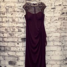 a dress hanging up against a brick wall