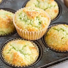 several muffins in a tray with nuts on the side