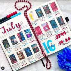 a calendar with red beads and blue flowers next to it on a sheet of paper