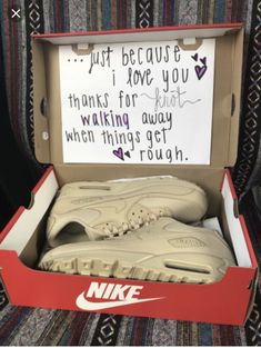 a pair of nike shoes in a shoe box with a note written on the inside