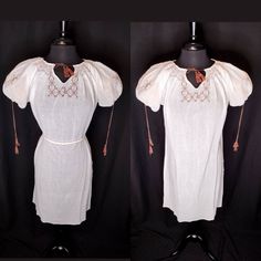 "✖️▪️✖️▪️✖️▪️✖️▪️✖️▪️✖️▪️ -Simple soft white cotton gauze peasant dress -Hand smocked around the collar -Nutmeg brown embroidery & tassels- on chest & sleeves -Loose shift style, perfect for summer lounging or as a night dress - puff sleeves can be tightened or loosened Size: flexible size, but about a medium for best fit. Fits well on the size 4 dress form shown on. Bust-44\" Waist-44\" Hip-44\" Length-43\" In very good vintage condition. Seam split on right side & some stitching coming out und Summer Peasant Prairie Dress For Daywear, White Bohemian Cotton Peasant Dress, Vintage White Peasant Top For Festival, Short Sleeve Peasant Top For Daywear, White Vintage Peasant Top For Festival, White Linen Peasant Dress, Short Sleeve Cotton Peasant Dress, Fitted Short Sleeve Bohemian Peasant Dress, Cotton Peasant Dress For Daywear