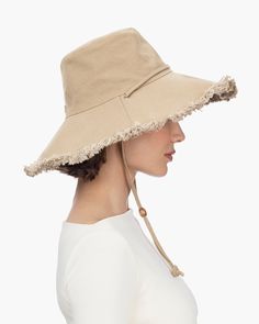 Women's elegant canvas sunhat for sale online, features a fringed edge and adjustable chin strap, which will secure it on the windiest of days. This soft, floppy hat is lightweight, breathable and provides complete coverage for your face, neck and ears. Soft, lightweight and packable. Rolls and folds into a tote bag. Brim span: 4.5" Adjustable chin strap. Durable 12 oz canvas 50+ UPF rating for the best in sun protection Blocks 98% of UVA/UVB rays Dry clean only. Wide Brim Sun Hat With Fringe, Adjustable Fringe Hats, Casual Fedora Hat With Fringe, Spring Brimmed Hat With Fringe, Spring Flat Brim Hat With Fringe, Casual Sun Hat With Fringe, Casual Hats With Fringe And Curved Brim, Casual Adjustable Sun Hat With Fringe, Adjustable Fringe Hat For Spring