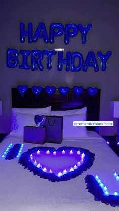 a bed with blue lights on it and a happy birthday sign above the bed that says,