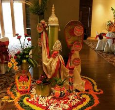 an elaborately decorated table with vases and flowers on the floor in front of it