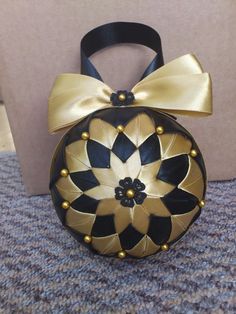 a black and gold purse with a bow on it