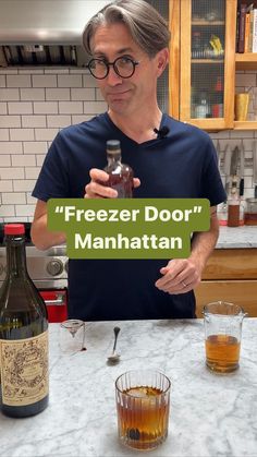 a man holding up a sign that says freezer door manhattan next to two shot glasses