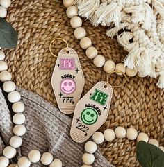 two key chains sitting on top of a table next to some beads and other items