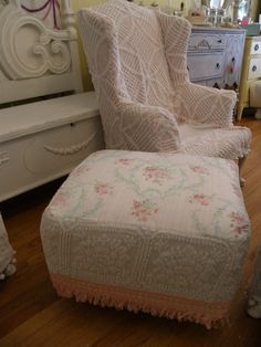 a white chair and footstool in a room