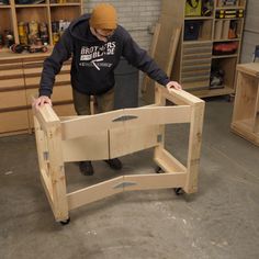 a man standing over a wooden table in a shop