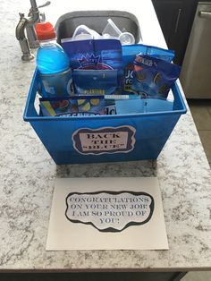 a blue box filled with personal care items sitting on top of a counter next to a sign