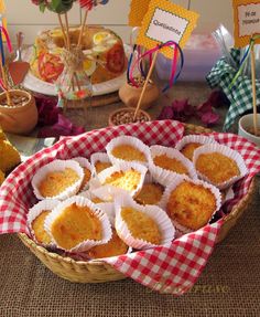 an assortment of desserts in paper cups on a table with red and white checkered cloth