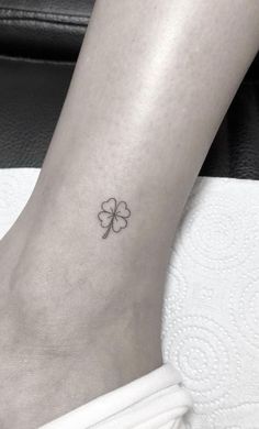 a small four leaf clover tattoo on the ankle