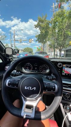 the interior of a car with steering wheel, dashboard and electronic display on it's screen