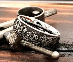 an old pair of scissors sitting on top of a wooden table