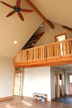 a living room with wooden floors and a ceiling fan