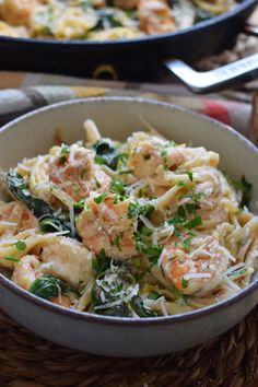 pasta with shrimp and parmesan cheese in a bowl