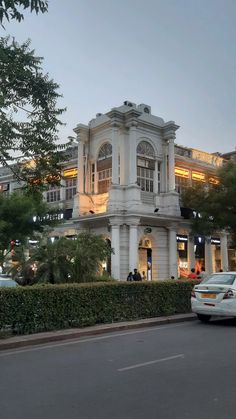 a large white building sitting on the side of a road