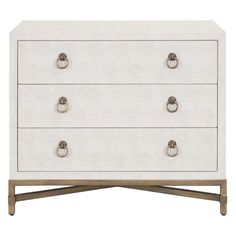 a white dresser with three drawers and two handles on each drawer, in front of a white background