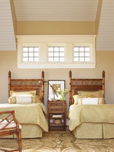 two beds in a room with wooden headboards and foot boards on either side of the bed