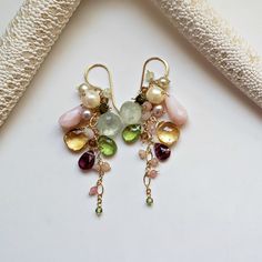 "Made to order. Production times for made to order items may be found in the shop announcement or the shop policies page. Soft pinks, shimmering golds, and sparkling greens drip down a luxurious chain. The first seven pictures are the earrings in rose gold filled, and the last three are in gold filled. ~ pink Peruvian opal, freshwater pearls, prehnite, rose quartz, Swarovski crystals, citrine, peridot, tourmaline, peach moonstone, rhodochrosite ~ rose gold filled, sterling silver, or gold filled Unique Long Drop Chandelier Earrings As Gift, Unique Long Drop Chandelier Earrings For Gifts, Whimsical Teardrop Jewelry For Pierced Ears, Whimsical Dangle Jewelry With Matching Earrings, Unique Briolette Earrings As Gift, Handmade Whimsical Teardrop Jewelry, Whimsical Handmade Teardrop Jewelry, Whimsical Teardrop Earrings For Pierced Ears, Whimsical Drop Earrings With Dangling Charms