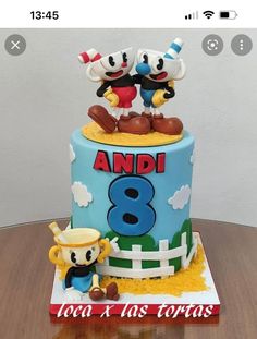 a birthday cake with two cartoon characters on top