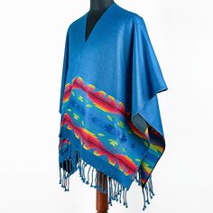 see other items AUTHENTIC FAIR TRADE PRODUCTS FROM ECUADOR Buy more items and save! Take a look on our SPECIAL OFFERS! Special Offers Tracked Shipping Top Quality SOFT&WARM BLUE ALPACA WOOL SOUTH AMERICAN PONCHO RUANA WRAP SHAWL CAPE OTAVALO This luxurious alpaca wool poncho-wrap will fit you perfectly. This gorgeous poncho features a unique design.  Our alpaca wool poncho is very soft to touch.   The poncho measures a total of approximately 166 cm (65 inches) wide and 126 cm (50 inches) from th Blue Shawl Poncho For The Beach, Blue Shawl Poncho For Beach, Blue Fringe Poncho One Size, Blue One-size Poncho With Fringe, One Size Blue Poncho With Fringe, Blue Bohemian Poncho With Fringe, Blue Winter Festival Poncho, Blue One-size Poncho For Festivals, One Size Blue Poncho For Festivals