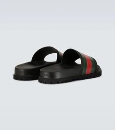 Accented with the label’s signature green and red stripes, these Gucci Web slider sandals are crafted entirely from rubber and feature a molded footbed, and track sole..Made in Italy.Designer color name: Black.Fits small to size - we recommend trying one size larger.UK sizes Gucci Green Flat Sandals, Green Flat Gucci Sandals, Red Gucci Sandals For The Beach, Green Round Toe Slides With Rubber Sole, Green Slip-on Slides With Rubber Sole, Gucci Green Sandals With Branded Insole, Green Sporty Sandals With Rubber Sole, Gucci Green Summer Sandals, Green Gucci Sandals For Summer