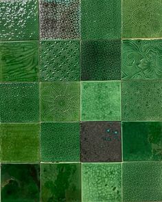 many different green and black tiles are arranged together