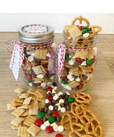 two glass jars filled with candy and pretzels