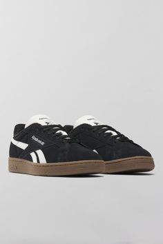 Reebok Club C Grounds UK sneakers. Reebok's iconic Club Cs with an '80s vintage feel, the Club C Grounds UK sneakers have a soft suede upper with smooth side stripes and heel tab. Features. Reebok Club C Grounds UK sneakers '80s aesthetic sneakers in soft suede Lace-up style Content + Care. Suede, rubber Spot clean Imported Aesthetic Sneakers, Reebok Black, 80s Aesthetic, Reebok Club C, Club C, Suede Lace, 80s Vintage, Side Stripe, The Club