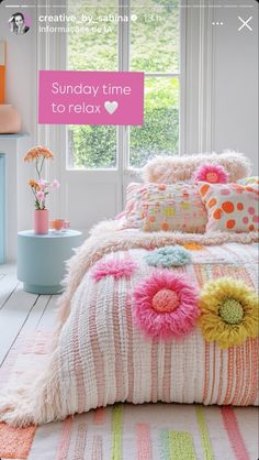 a bed room with a neatly made bed and flowers on the comforter, next to a window