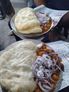 two plates filled with food on top of paper