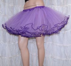 "The main fabric is soft Pastel Purple Lavender Bridal Tulle. The waistband is dark purple cotton over elastic. Then I finished it off with more purple piping on the hem. This skirt is stitched and serged to last a lifetime. It's safe for the washing machine and the dryer. Measurements: Waist Size Small: 24\" to 32\" Medium: 33\" to 42\" Large: 42\" to 50\" Length: 14\" NOTE This listing is only for the Purple piped tulle skirt. The matching cotton circle skirt is NOT included, but available in Halloween Stretch Tulle Petticoat, Stretch Tulle Petticoat For Halloween, Fitted Purple Tutu Dress For Spring, Purple Fitted Skirt For Cosplay, Fitted Purple Skirt For Cosplay, Purple Ruffled Tutu Dress For Wedding, Purple Party Tulle Petticoat, Purple Tulle Petticoat For Party, Fitted Purple Petticoat For Party