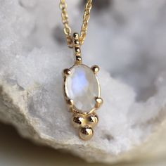 - Rose cut Oval Rainbow Moonstone measures 6 x 4mm  - Moonstone gives off hints of blue and purple in the light - Natural inclusions give a different texture to each stone, making each necklace one of a kind!   - Available on a 16" or 18" chain - Available in 14K white, rose, or yellow gold (pictured in yellow gold) - 1mm classic cable chain - Finished with a spring ring - Milgrain accented pendant Interested in a different gemstone?  Please contact me.  Processing times -  Current processing ti Oval Moonstone Natural Stones, Oval Natural Moonstone Gemstones, Oval Moonstone Gemstones With Spiritual Style, Spiritual Oval Moonstone Necklace, Handmade Oval Moonstone Necklaces, Oval Moonstone Gemstone Necklace, Oval Moonstone Cabochon Necklace, Handmade Oval Moonstone Necklace, Moonstone Gemstone Oval Necklace