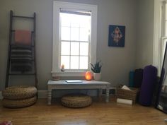 a living room filled with furniture next to a window and a ladder in the corner