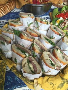 a bunch of sandwiches are stacked on top of each other with herbs in the middle