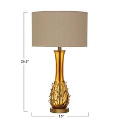 the golden glass table lamp has a beige shade on it's base and is measurements for