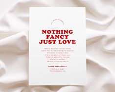 a red and white wedding card with the words nothing fancy just love