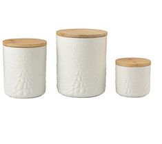 three white ceramic jars with wooden lids