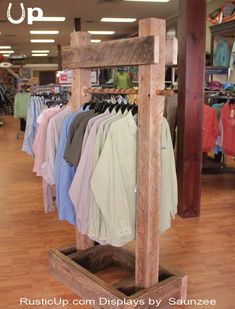 clothes are hanging on racks in a clothing store